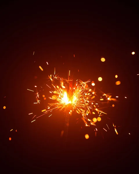 Christmas sparkler in haze with red light — Stock Photo, Image