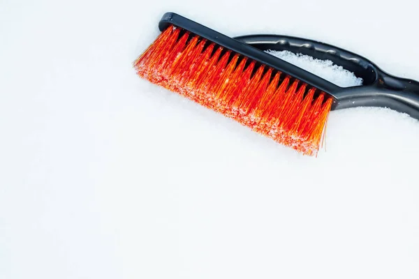 Orange snow brush for car, snowflakes background — Stock Photo, Image