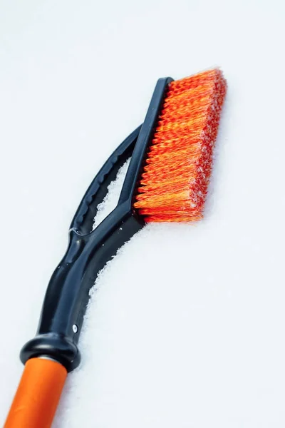 Orange snow brush for car, snowflakes background — Stock Photo, Image