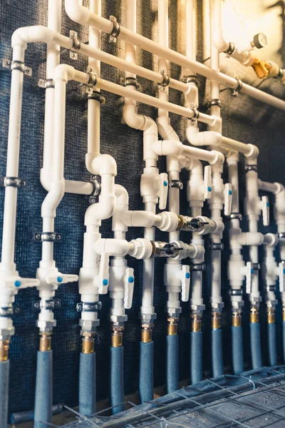 white plastic pipes in boiler room