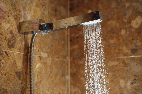 Hot shower with water stream — Stockfoto