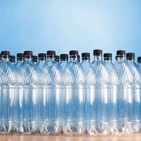 Empty plastic bottles on blue background — Stock Photo, Image