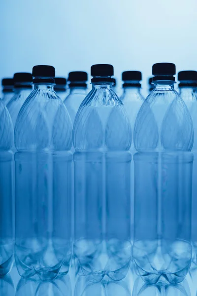 Empty plastic bottle silhouettes on blue background — Stock Photo, Image