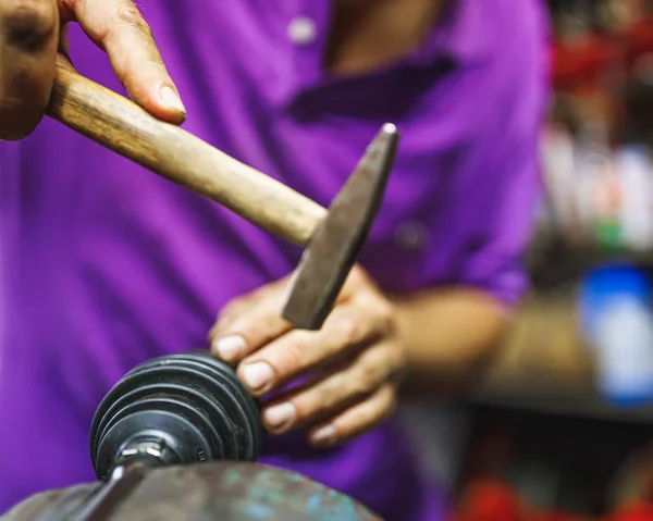 ATV constant-velocity CV joint repair, hammer in by hands — Stock Photo, Image