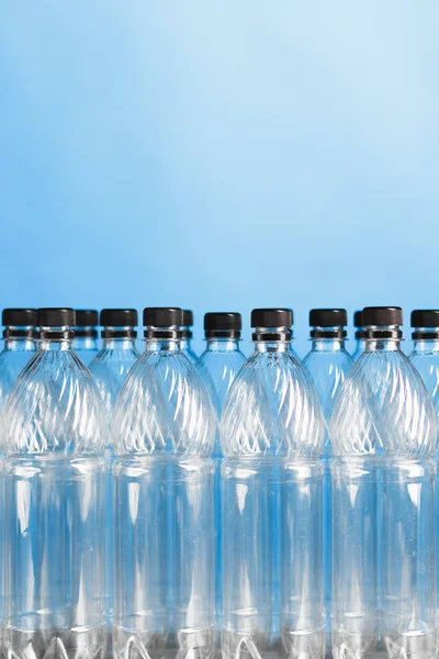 Empty plastic bottles on blue background — Stock Photo, Image