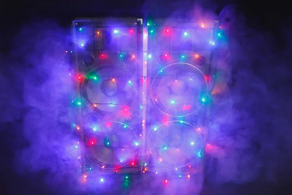 Music speakers with festive Christmas lights and smoke — Stock Photo, Image