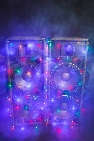 Music speakers with festive Christmas lights and smoke — Stock Photo, Image