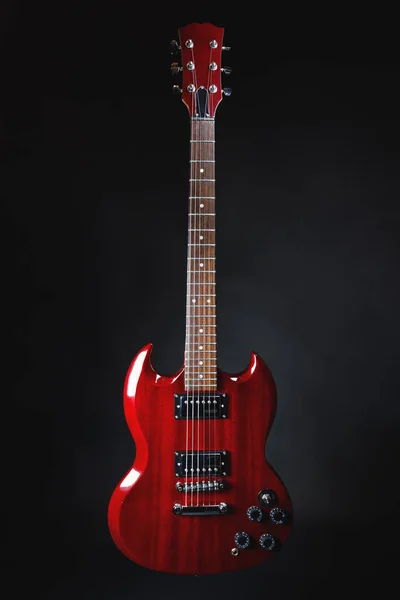 Red electric guitar on dark gray background — Stock Photo, Image