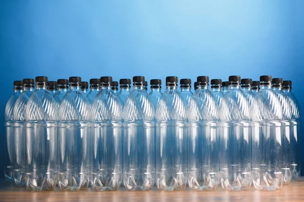 Empty plastic bottles on blue background — Stock Photo, Image