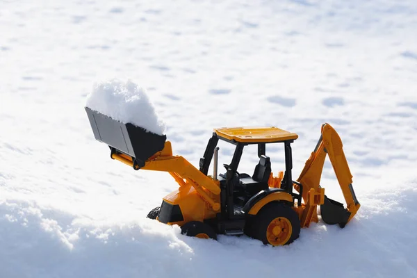 Tractor toy removes snow out of the way — Stock Photo, Image