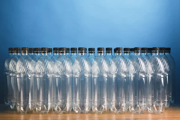 Empty plastic bottles on blue background — Stock Photo, Image