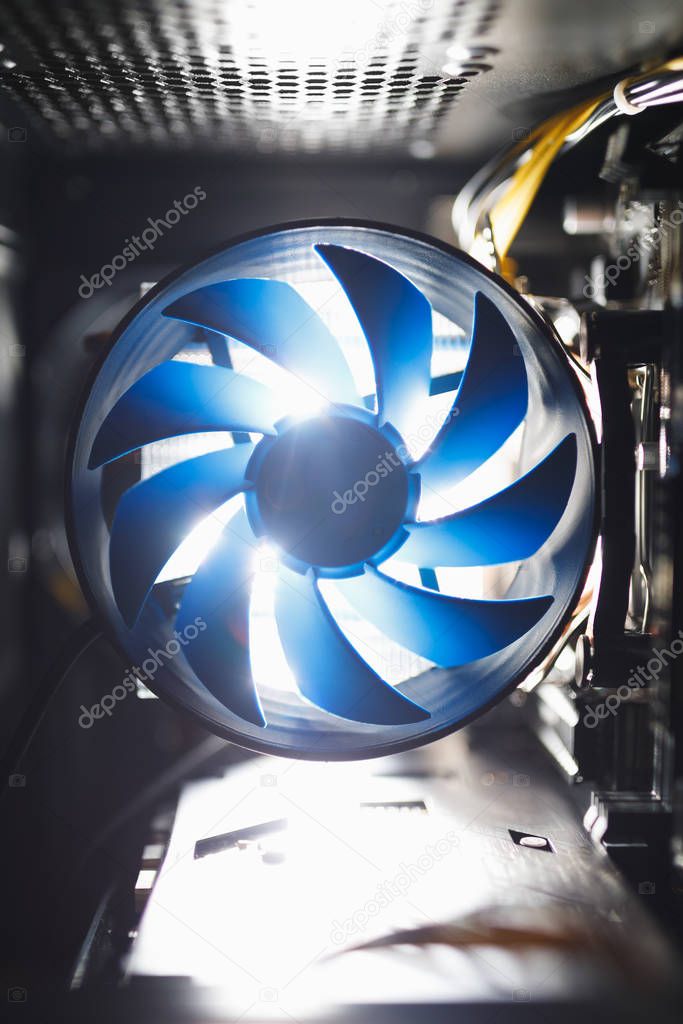 blue cpu cooler inside PC case, shiny light background