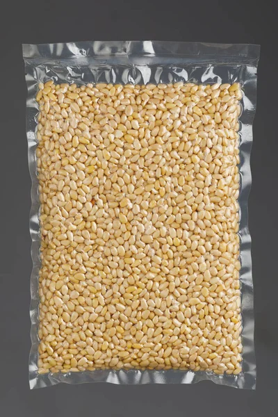 pine nuts packed in vacuum bag, gray background