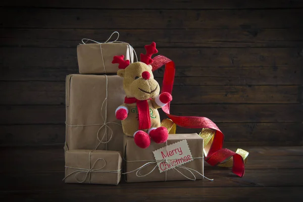 Christmas gifts on a wooden background — Stock Photo, Image