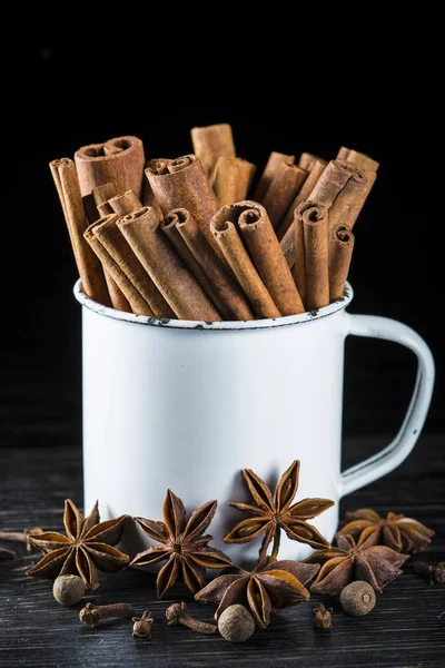 Porcelain cup full of cinnamon sticks — Stock Photo, Image