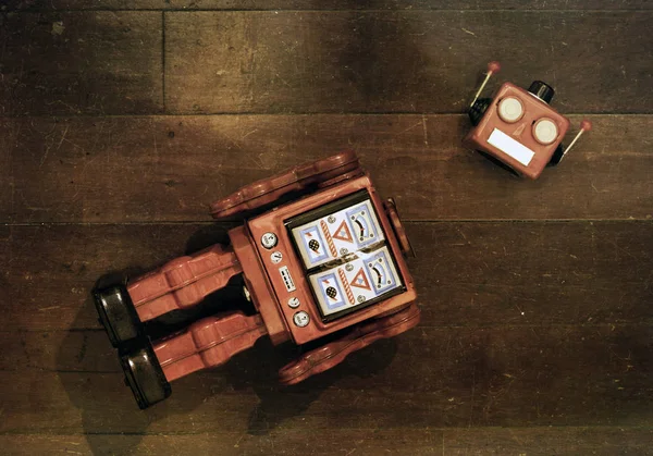 Retro red robot has lost his head on a old wooden floor — Stock Photo, Image
