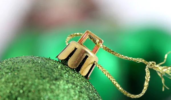 Green decorative christmas ball detail. gold colored hanging rope.macro shot in studio, — Stock Photo, Image