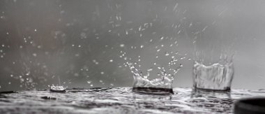 bir masa yüzeyine düşen yağmur damlaları