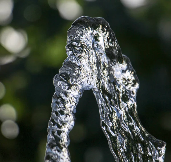 Fresh water flows from hose against blurr background — Stock Photo, Image