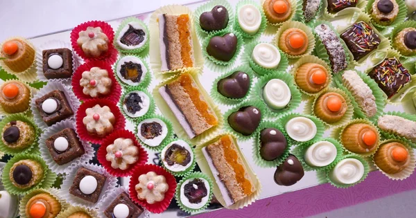 Hart vorm gemaakt van verschillende chocolade bonbons geïsoleerd op wit — Stockfoto
