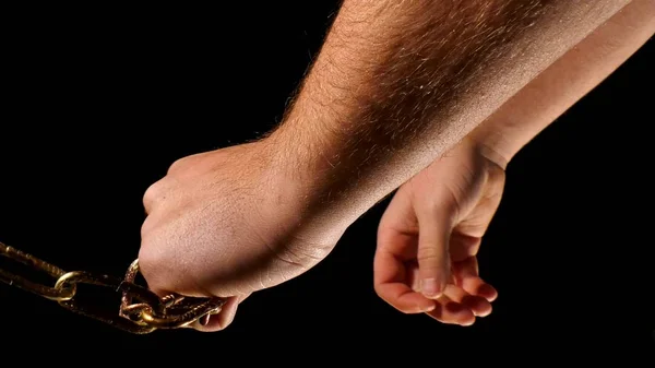 Man hand and gold colored chain on black — Stock Photo, Image