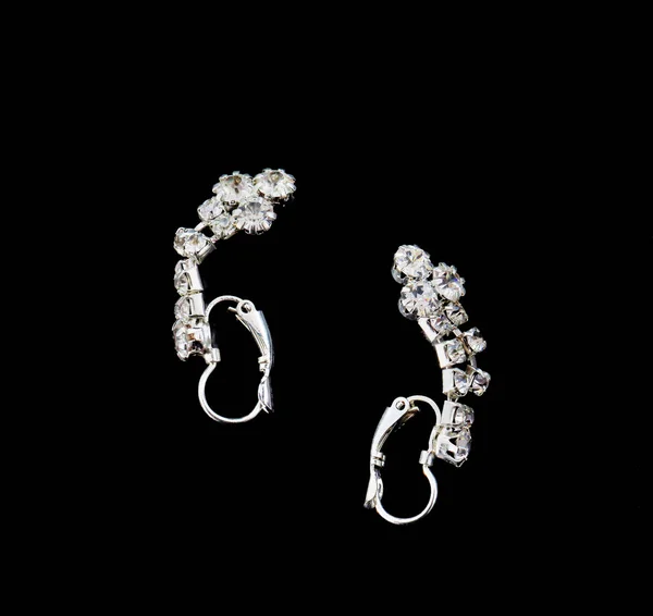 Pair of a fashion silver earrings with precious stones Royalty Free Stock Photos