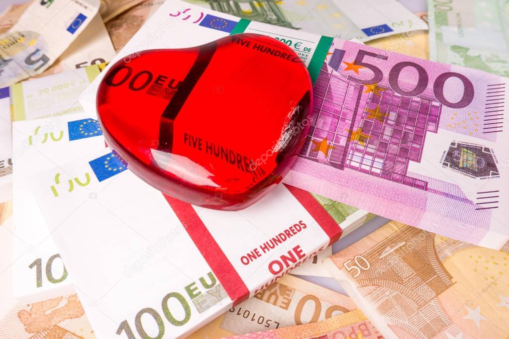 Glass heart with Euro. euro banknotes.  love and money