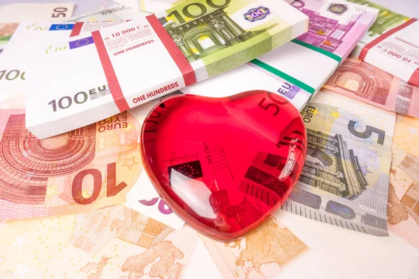 Glass heart with Euro. euro banknotes.  love and money — Stock Photo, Image