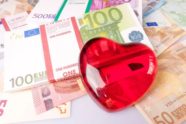 Glass heart with Euro. euro banknotes.  love and money — Stock Photo, Image