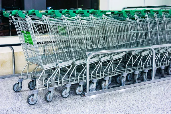 Shopping carts on a parking lot. Metal Shop carts — Stock Photo, Image