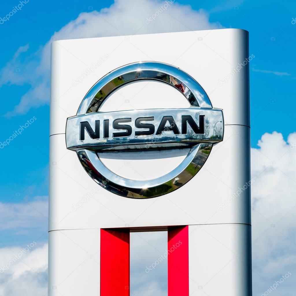 GERMANY, MOENCHENGLADBACH -APRIL 16, 2017: Logotype of Nissan corporation. Nissan company logo on dealership building