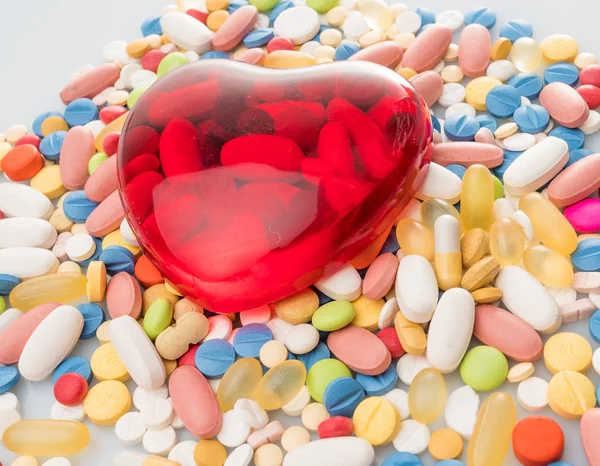 Corazón con pastillas. pastillas de colores. antecedentes médicos —  Fotos de Stock