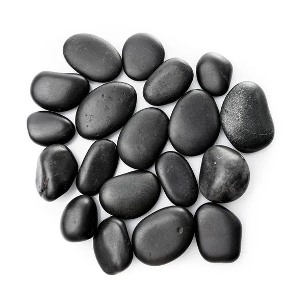 Piedras de masaje en blanco. Piedras negras aisladas — Foto de Stock