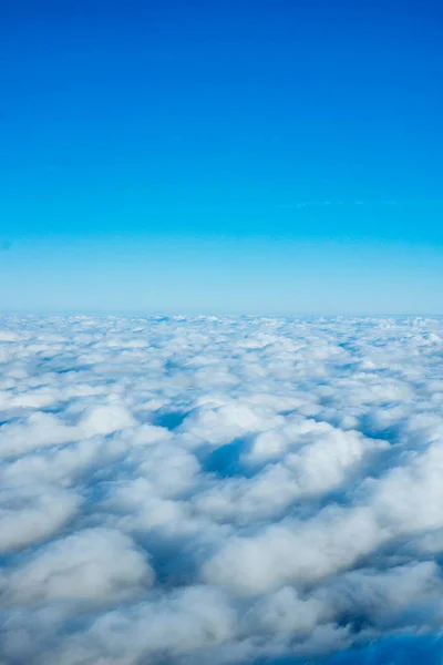 Bulutlar uçak penceresinden. Bulutların üstünde gökyüzünün görünümü — Stok fotoğraf