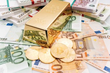 Avro banknotları ve altın külçeleriyle Bitcoin Btc Gold sikkeleri. Bitcoin ve altın Euro banknotlarında yatıyor