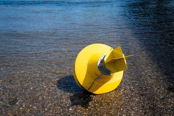 Yellow Anchor buoy on drought river — Stock Photo, Image