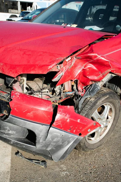 Front of red car get damaged by accident on the road — Stock Photo, Image