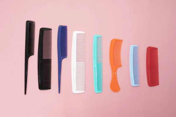 Various colored brushs and combs for hair on pink background. co — Stock Photo, Image