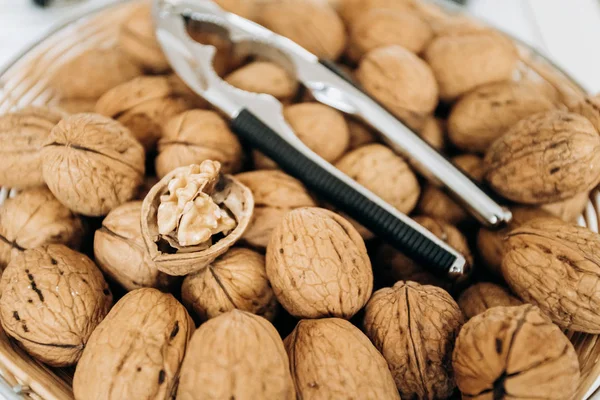 Nutcracker and walnuts in a large bowl — Stock Photo, Image