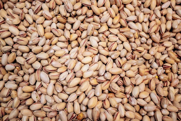 Background make from salt pistachios in a shell. A lot of pistachio nuts — Stock Photo, Image