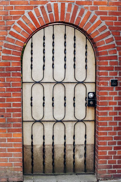 Old arched doors with wrought iron bars — Stock Photo, Image