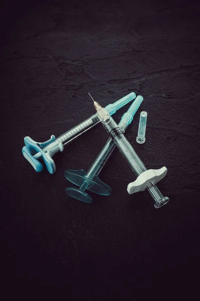 Cosmetology  injections. Plastic syringe on black background. M — Stock Photo, Image