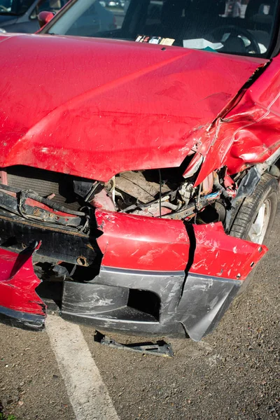 Front of red car get damaged by accident on the road — Stock Photo, Image