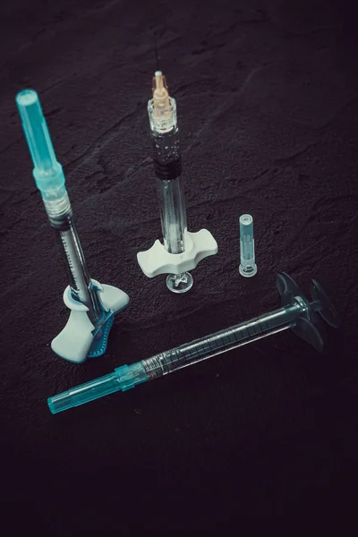 Cosmetology  injections. Plastic syringe on black background. M — Stock Photo, Image