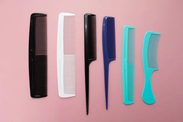 Various colored brushs and combs for hair on pink background. co — Stock Photo, Image