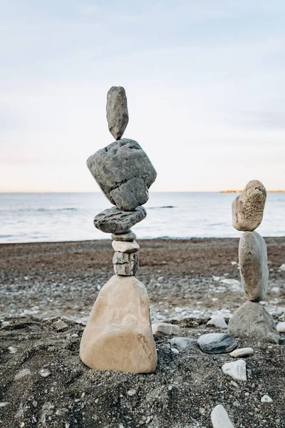 Figures of stones on the beach. Beautiful figures of stones on the background of the sea.