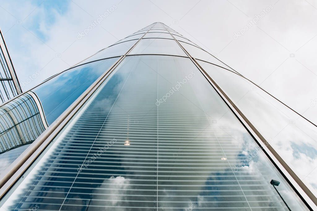 Reflection of the sky on a skyscraper. View of skyscrapers from below
