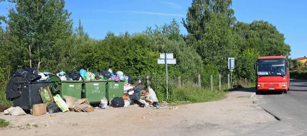 Latas de basura superpobladas junto a la parada de autobús — Foto de Stock