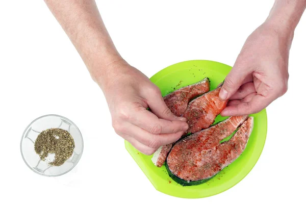 The hands of the old grandpa cook sprinkled  spices and herbs  o — Stock Photo, Image