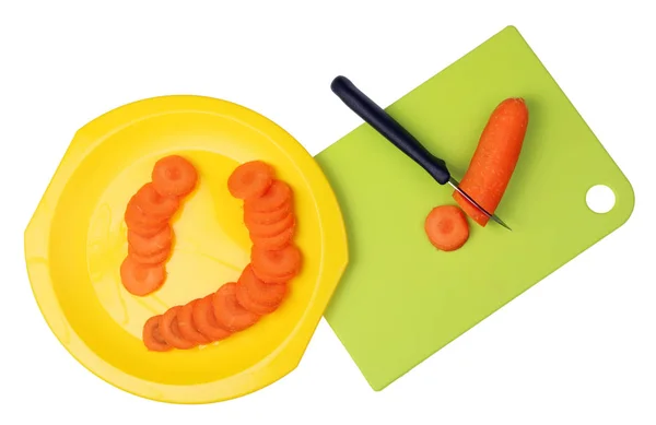 На пластиковой кухонной доске нож режут апельсиновой морковкой в ро — стоковое фото